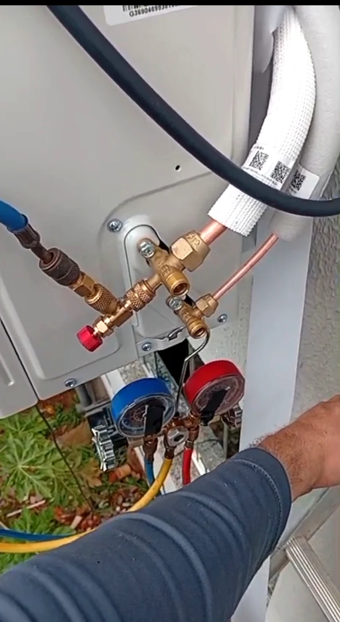 Manifold conectado à unidade externa durante verificação do sistema de ar-condicionado